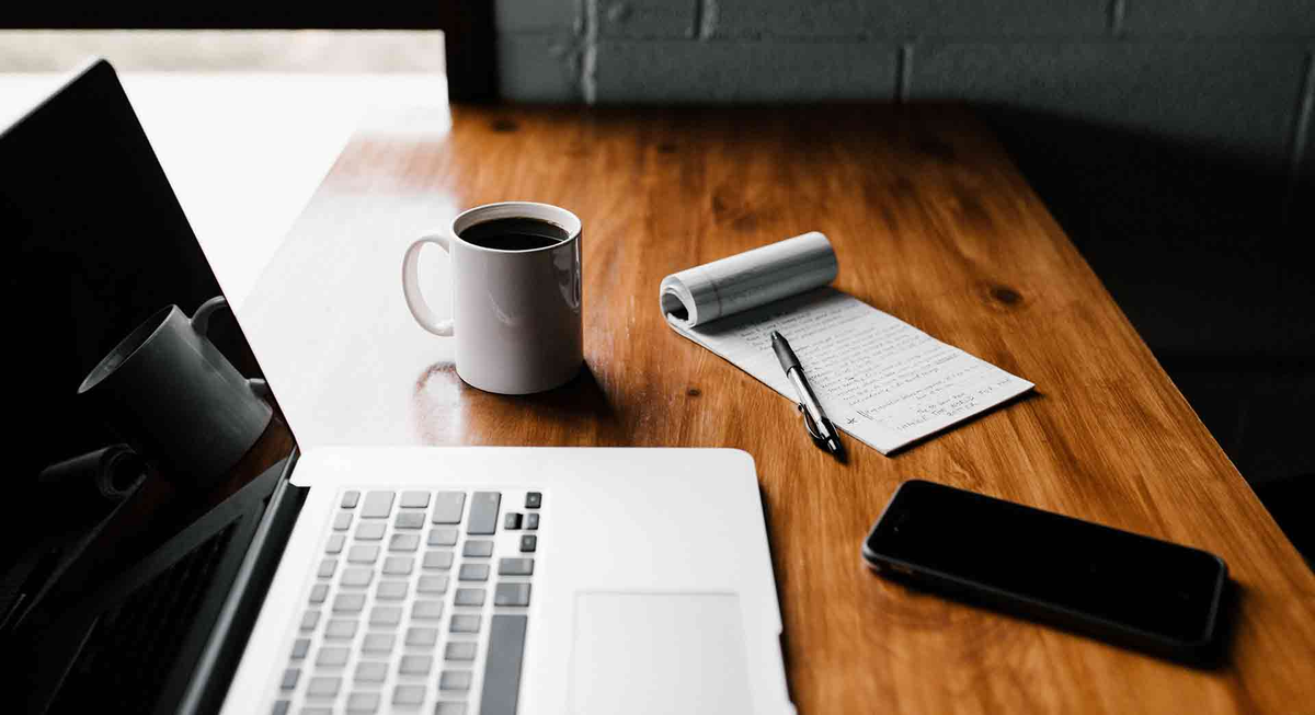 Laptop and notepad on a desk, from InMotion Hosting's site