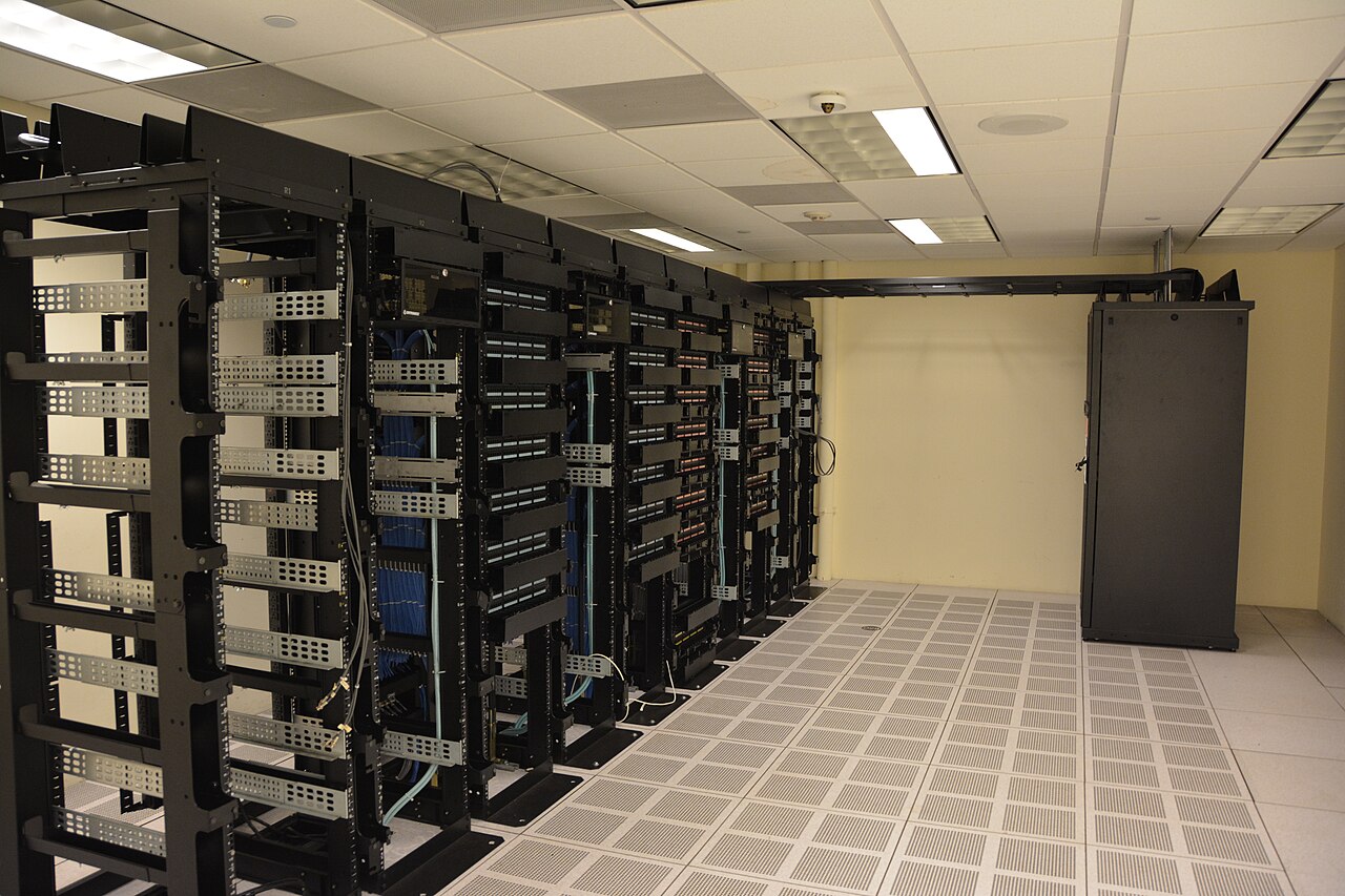 Rows of liquid-cooled server racks in a data center, the kind of deployment AMD's Helios rack targets