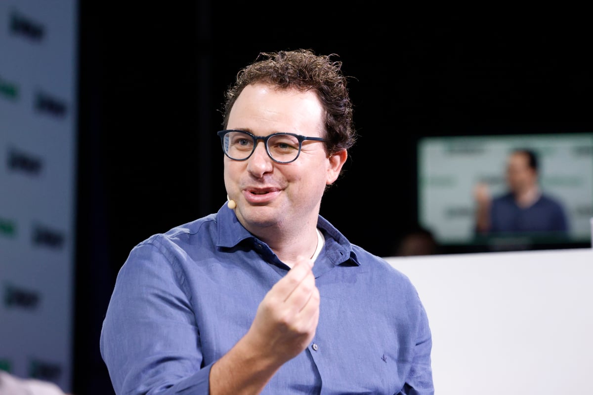 Dario Amodei speaking on stage at a technology conference