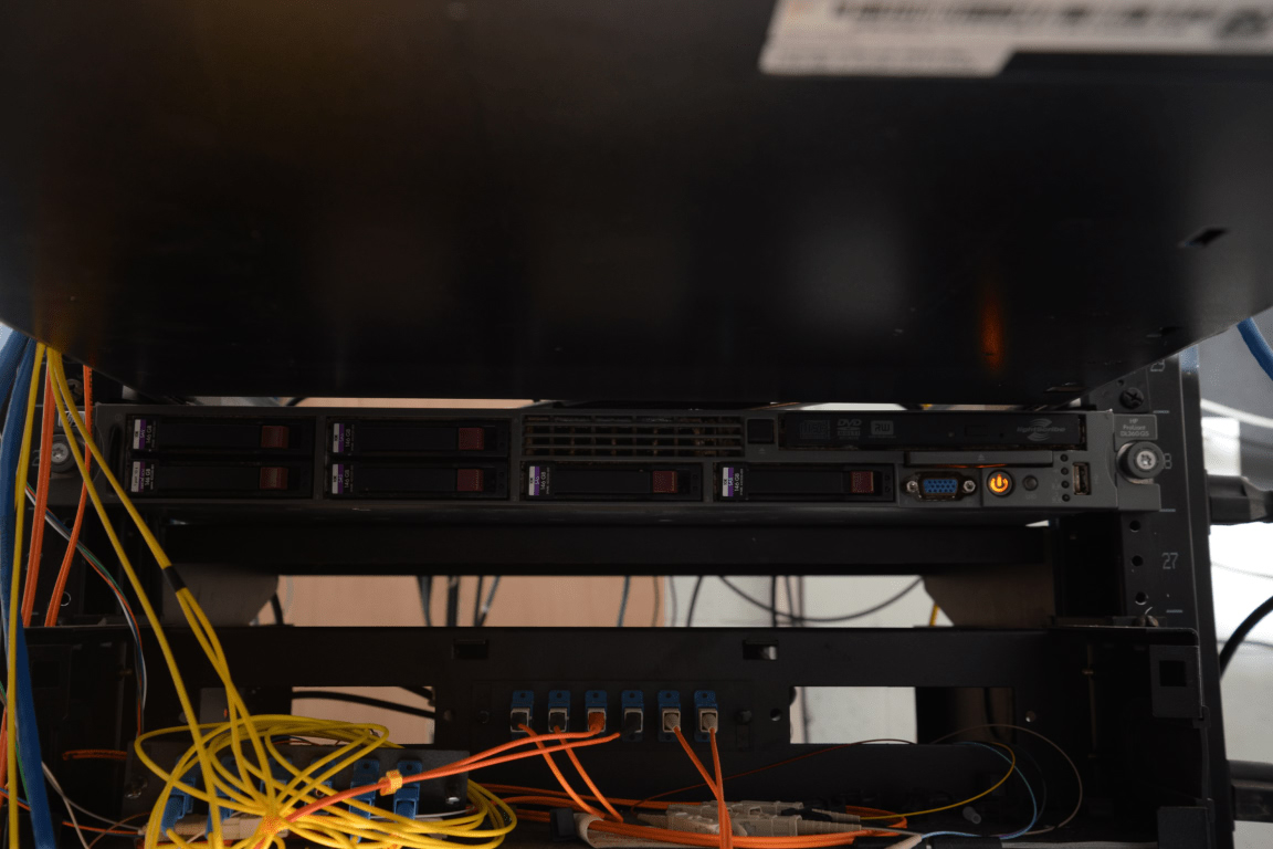 Server rack with hard drives and network cables in a data center