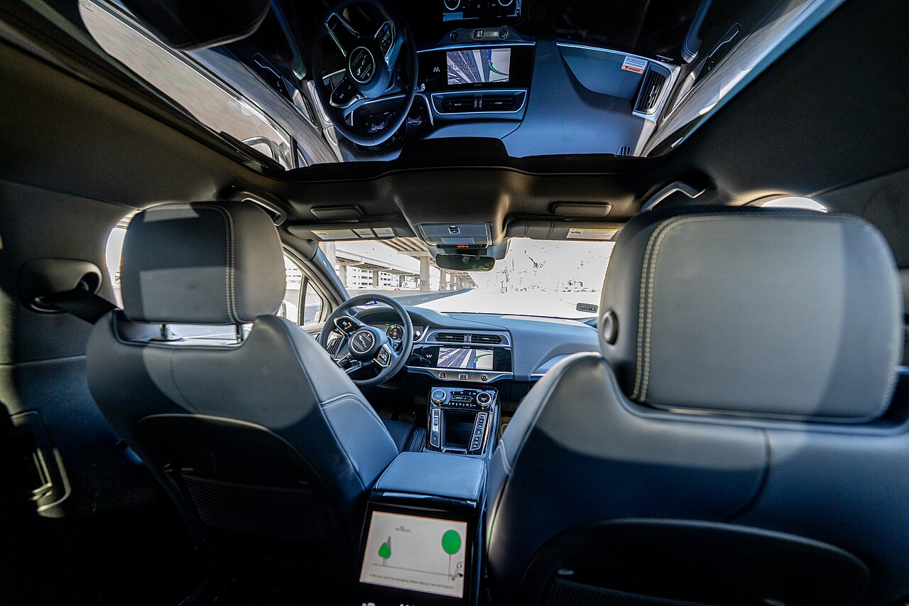 Interior of a Waymo Ojai showing seats and in-cabin screens